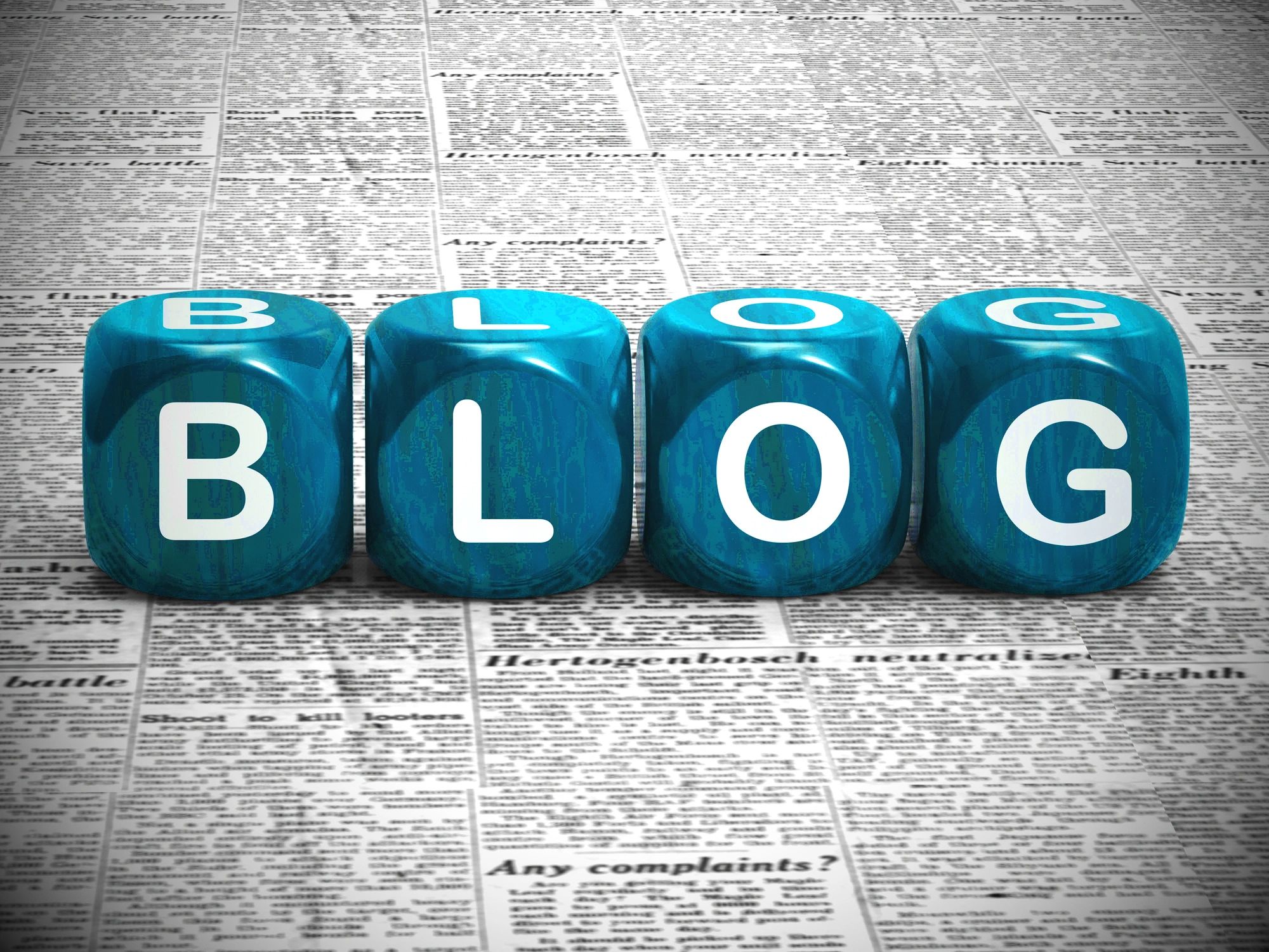 Blue dice spelling out BLOG on a newspaper background