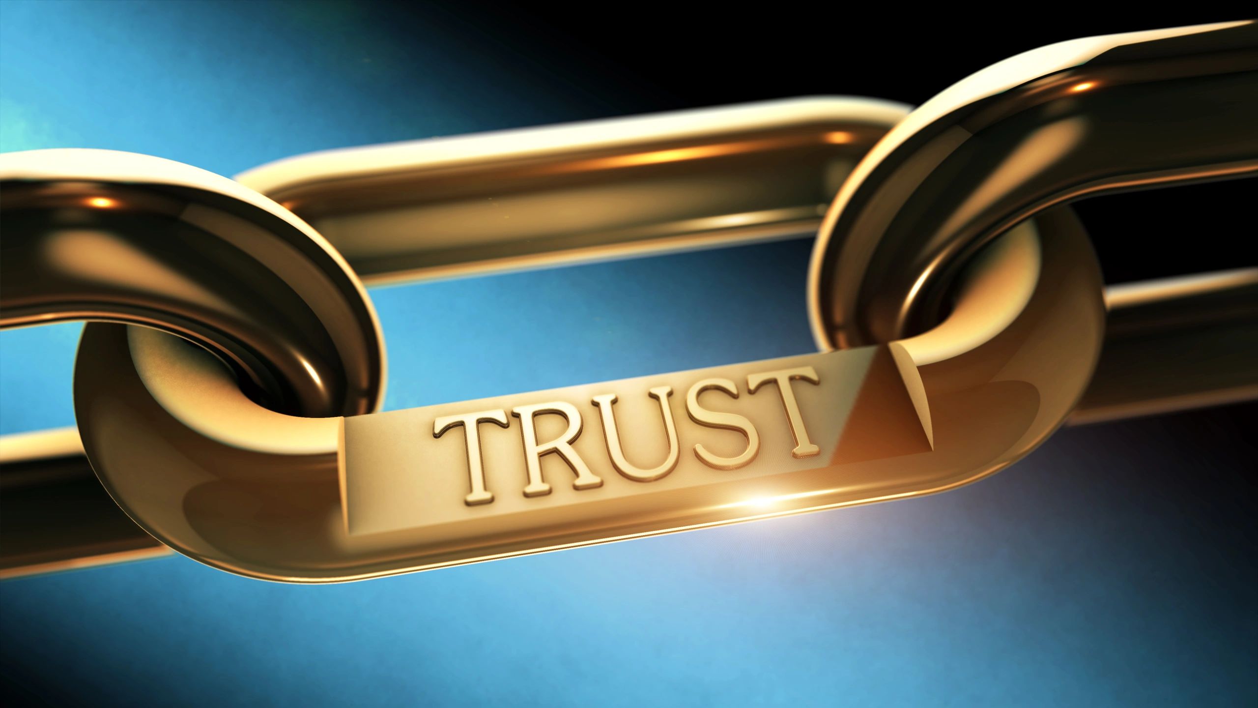 Golden chain link with the word TRUST embossed on it