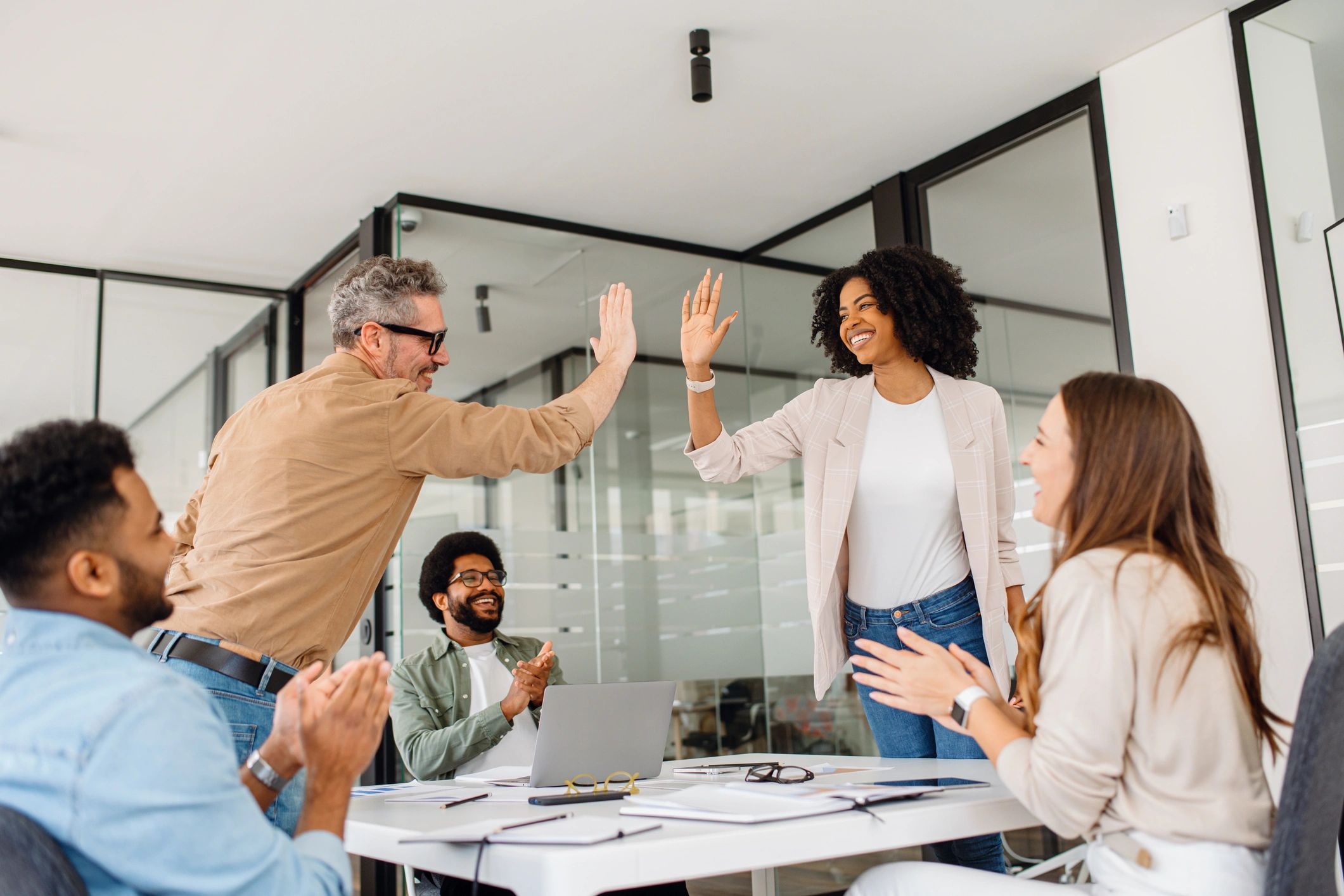 Diverse team celebrating success with high-five